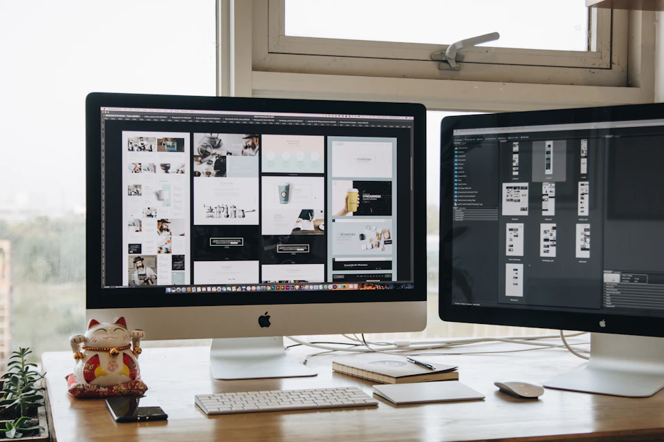 Two monitors side by side on a desk