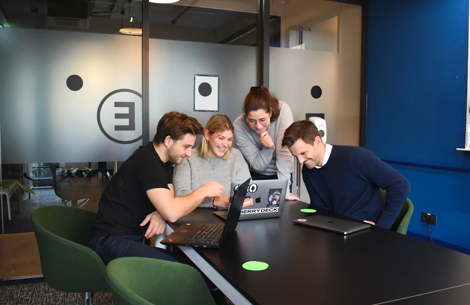 People sitting in front of laptops in an office