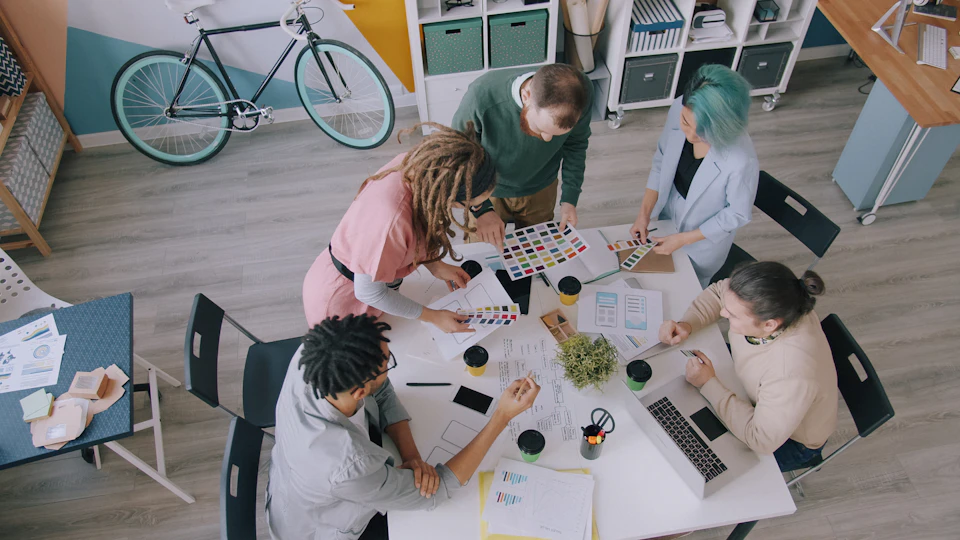 Design projects spread across a shared workspace table
